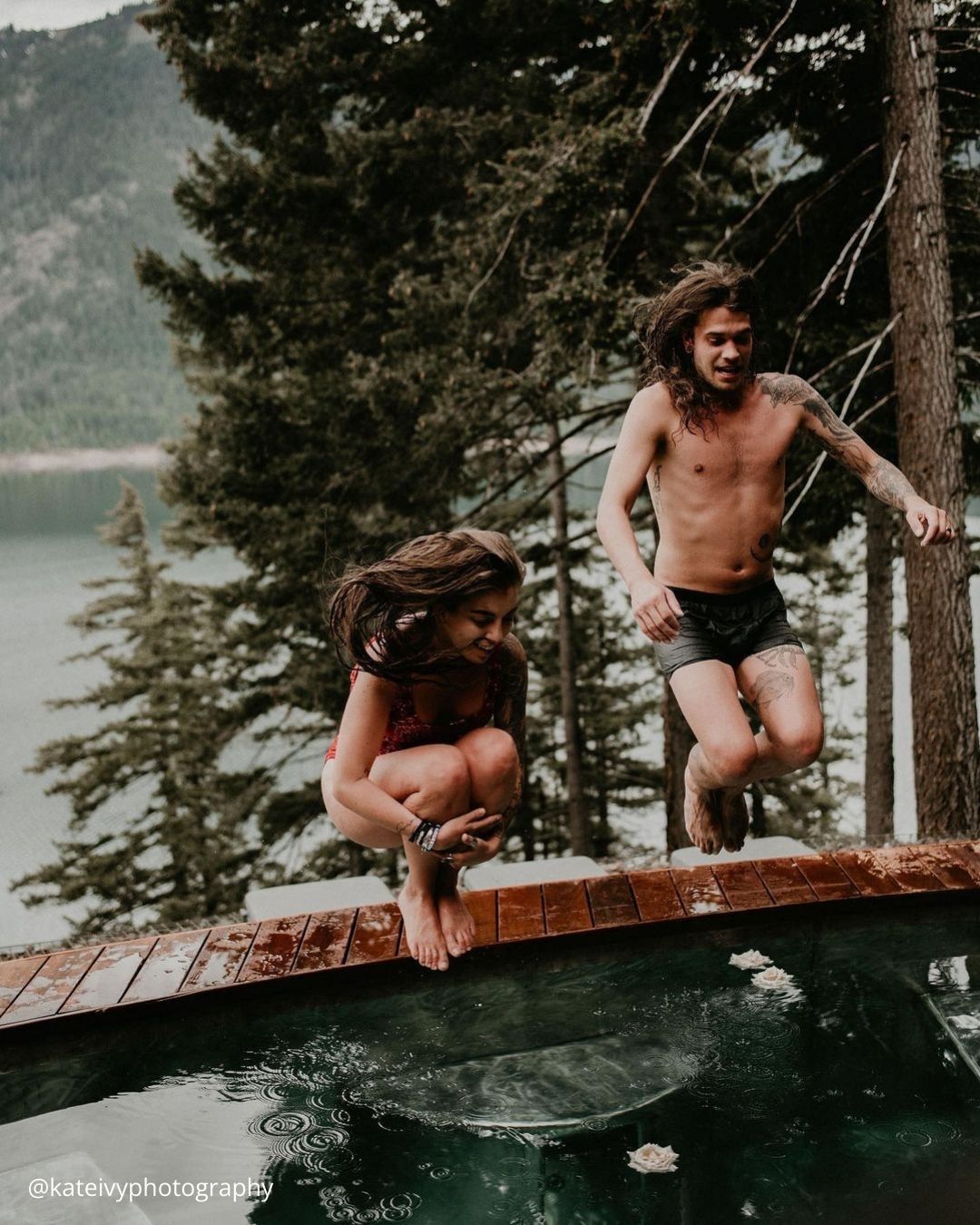 winter engagement photos couple is jumping into the winter pool