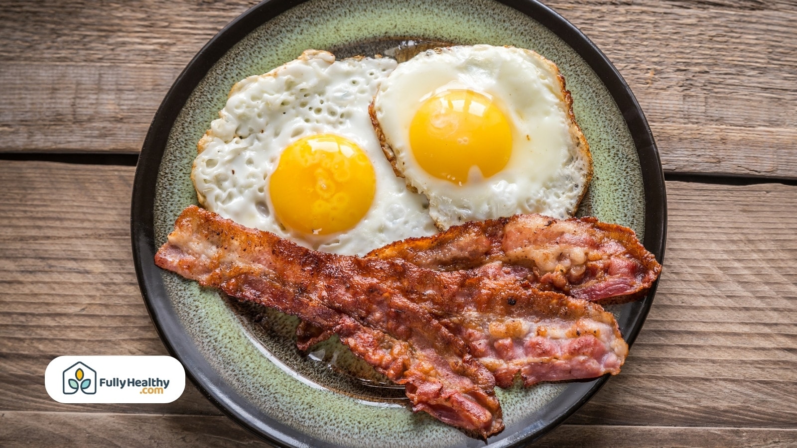 Two eggs and bacon strips on a plate