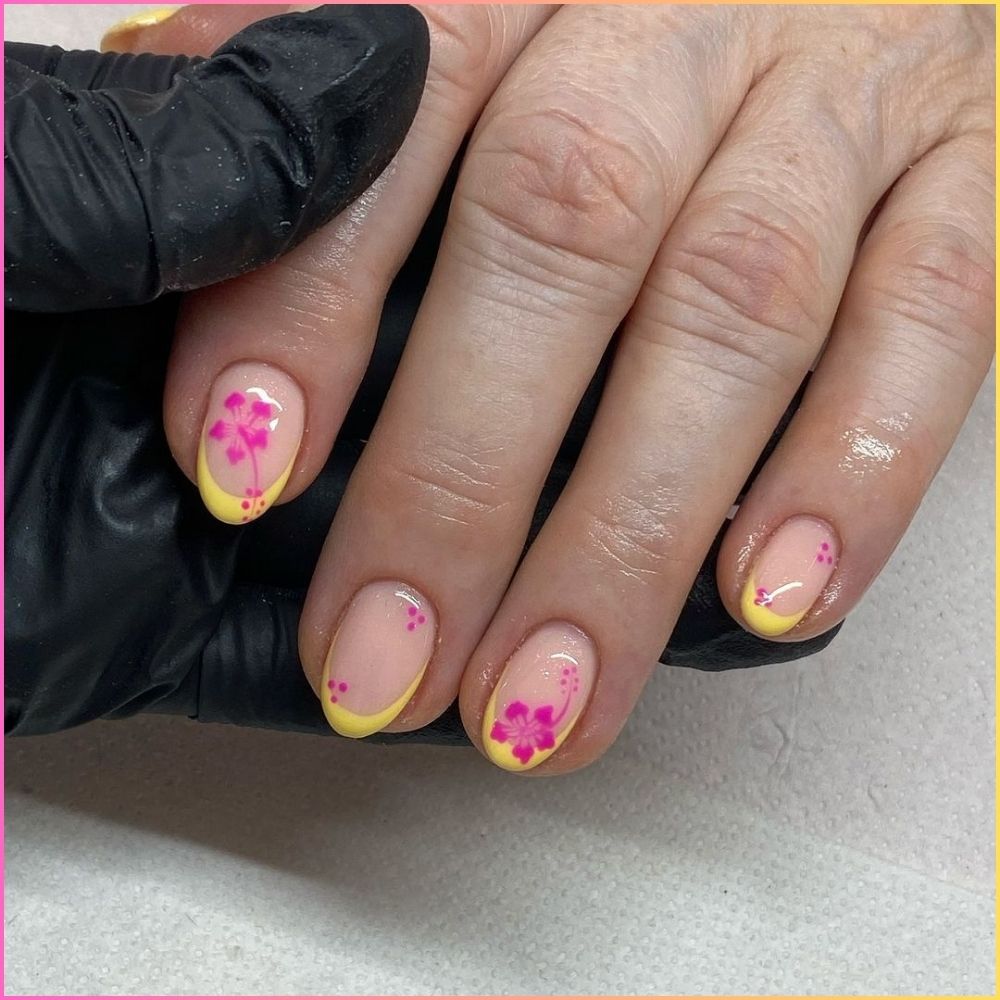 Close up of flowered short nail design with hibiscus flower with yellow tips