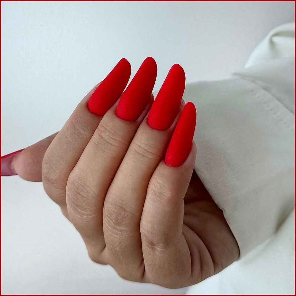 Close up of hands having Christmas red nails with Matte Red Magic