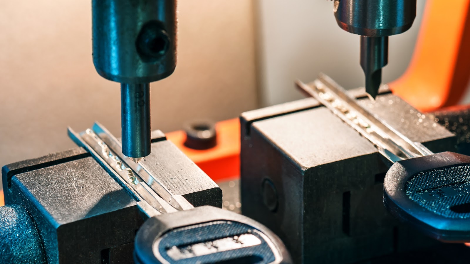 A close-up view of a machine cutting a spare car key with precision.