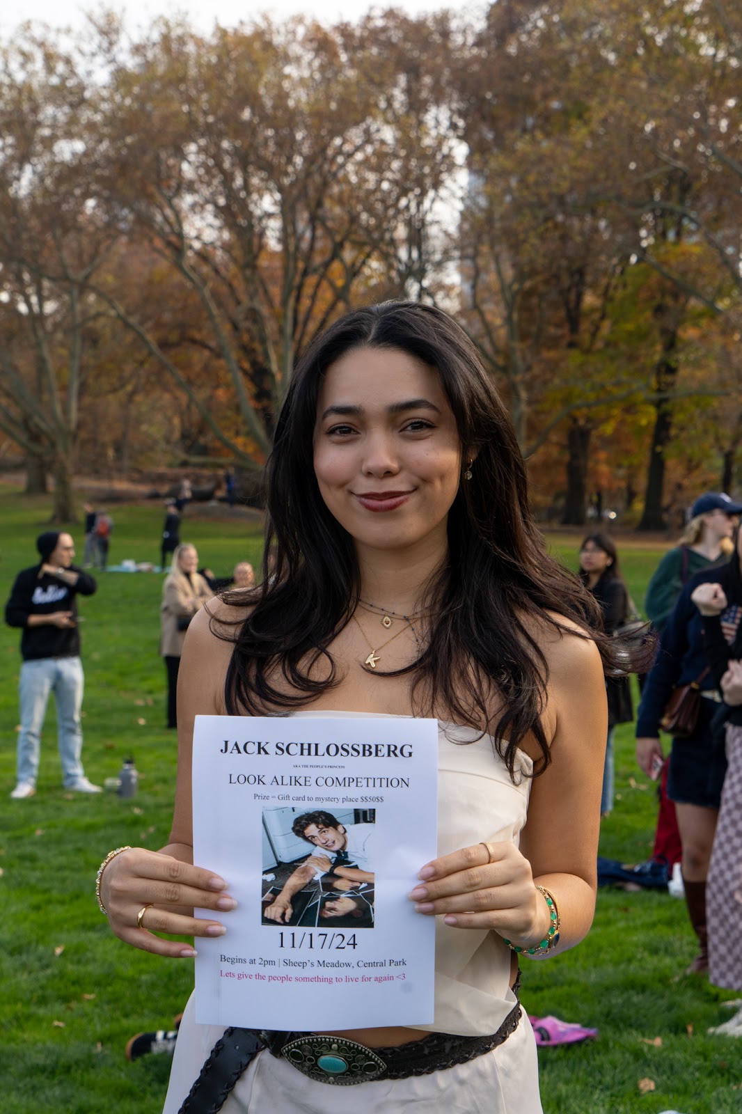 An image of the organizer of the Jack Schlossberg look-alike contest, holding the poster she made.
