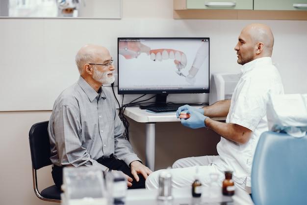 Old man sitting in dentist office