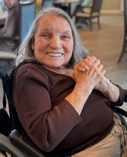 Woman sitting down and smiling
