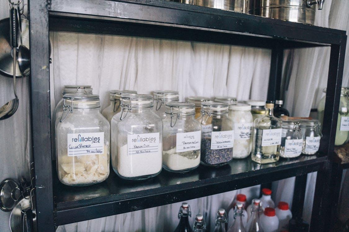 Free Organized glass jars on a pantry shelf for eco-friendly food storage and sustainability. Stock Photo