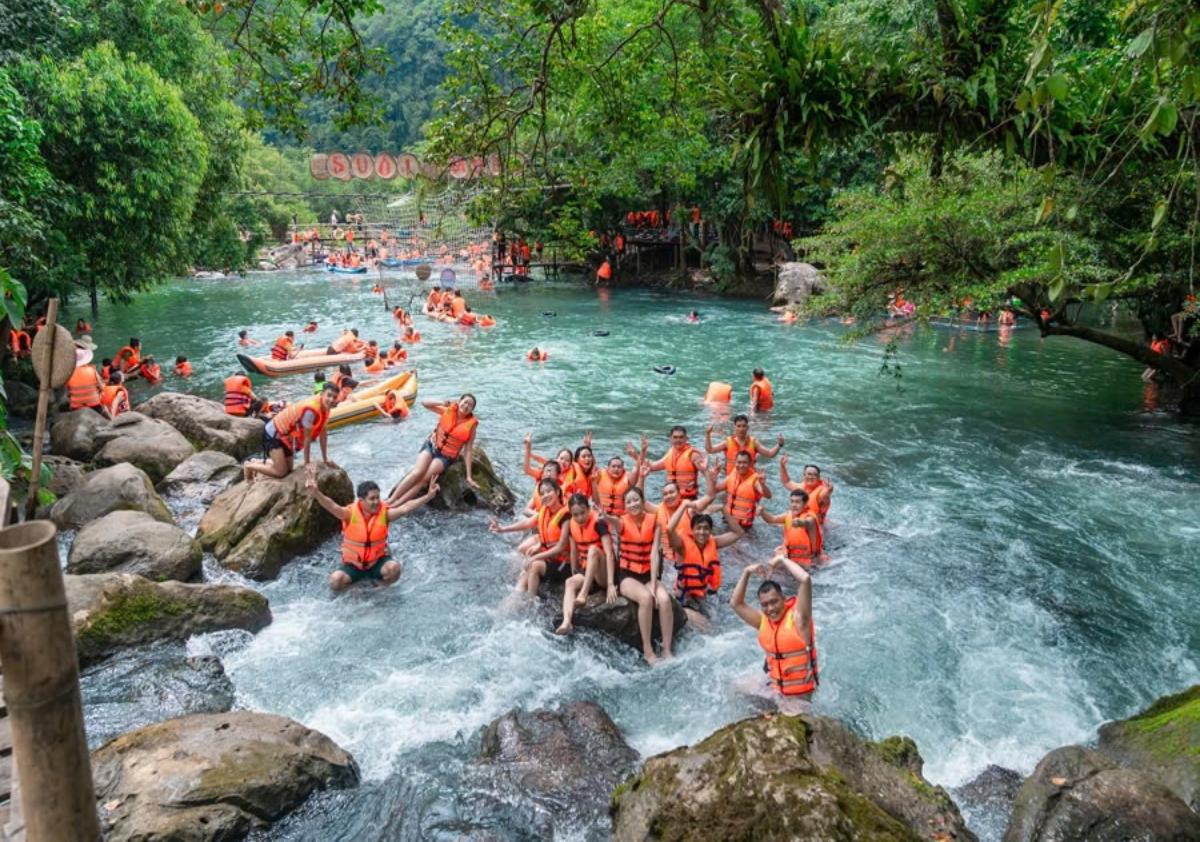 A group of people in a river

Description automatically generated