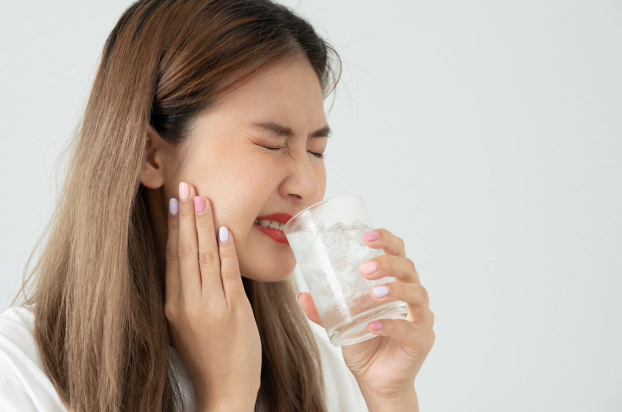 Person experiencing tooth sensitivity