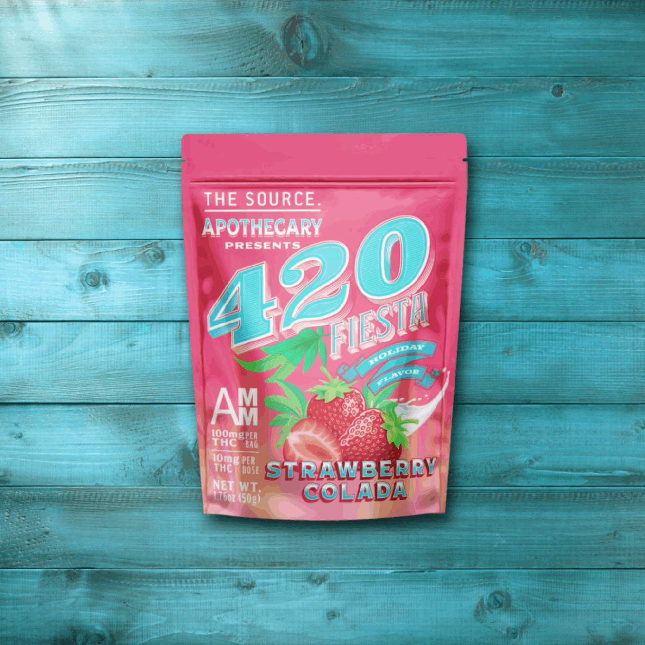 Image depicts The Source Apothecary’s new 420 Fiesta Limited-Edition flavor, Strawberry Colada. The image shows the blue kraft paper packaging on top of a tinted blue wood background. Inside of the packaging are high quality cannabis infused edibles from The Source Craft Cannabis Company in Rogers, Arkansas.