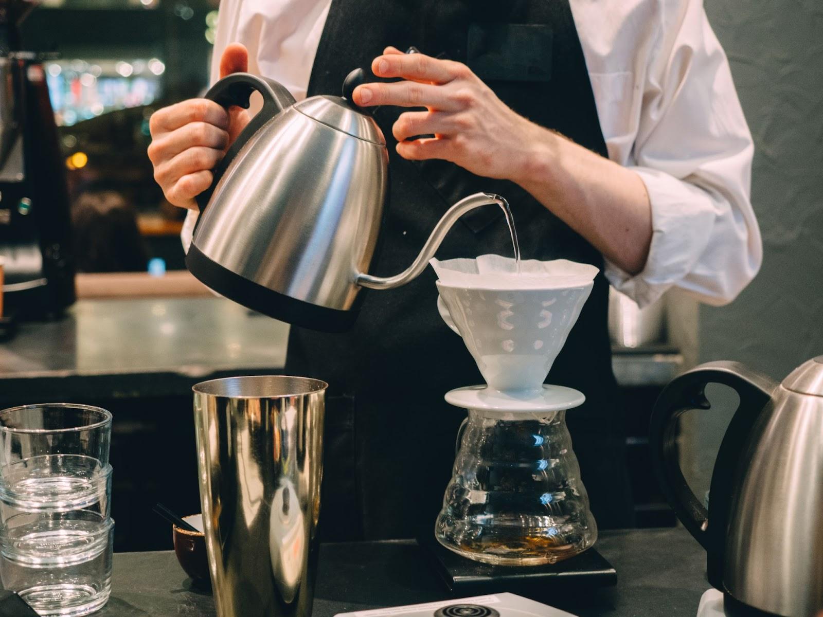 A barista making V60 coffee