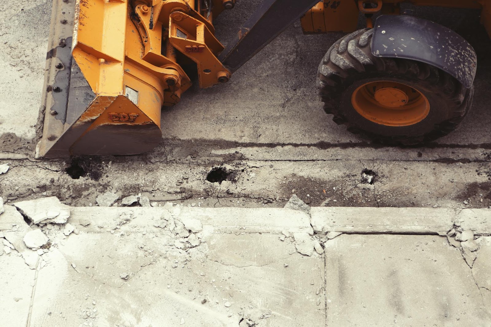 A yellow bulldozer on a construction site, symbolizing halted real estate projects or cancelled developments in Dubai.