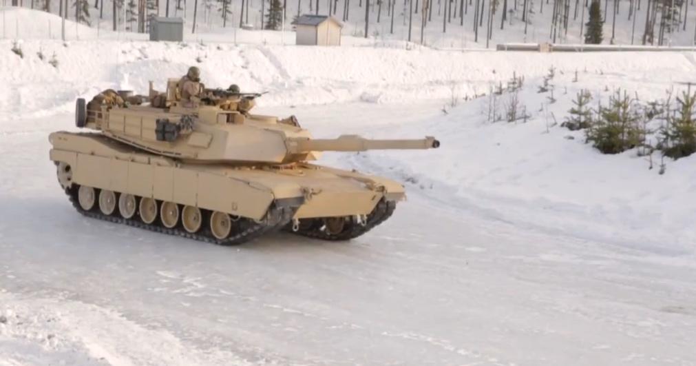 A tank driving through the snow

Description automatically generated