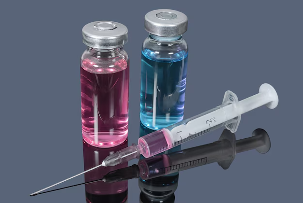 syringe-with-pink-liquid-next-to-two-vials-containing-pink-and-blue-solution-on-reflective-surface-how-i-used-pancragen-to-fix-my-fasting-crashes-and-rebuild-metabolic-flexibility-tony-huge