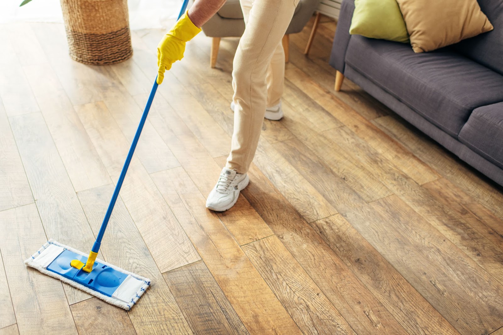 A woman mops a hardwood floor.