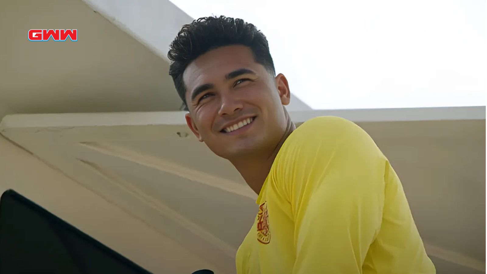 Alex Aiono smiling in lifeguard uniform from Rescue HI-Surf series