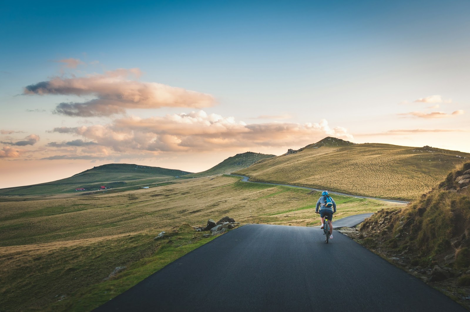 Person cycling down a long road