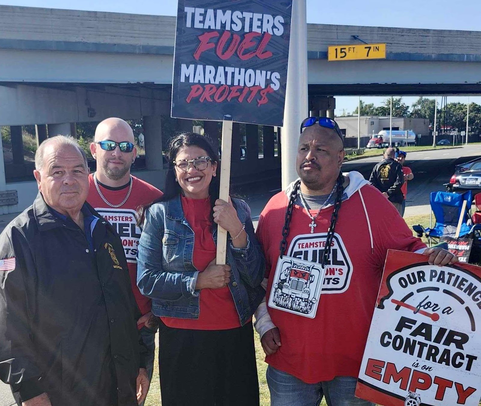 Rashida stands on a picket line with striking workers