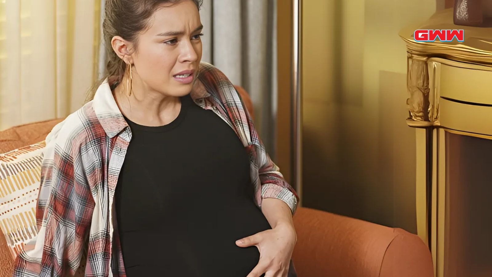 Alyssa Diaz holding her stomach as Angela Lopez in The Rookie Series