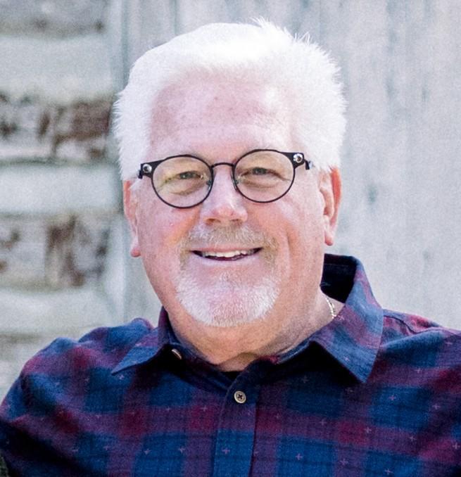 A person wearing glasses and a plaid shirtAI-generated content may be incorrect.