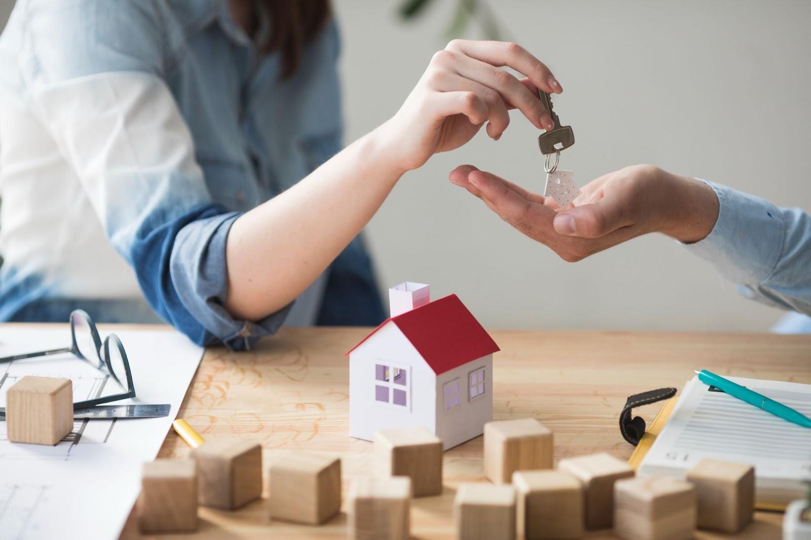 A person handing over a key to another personAI-generated content may be incorrect.