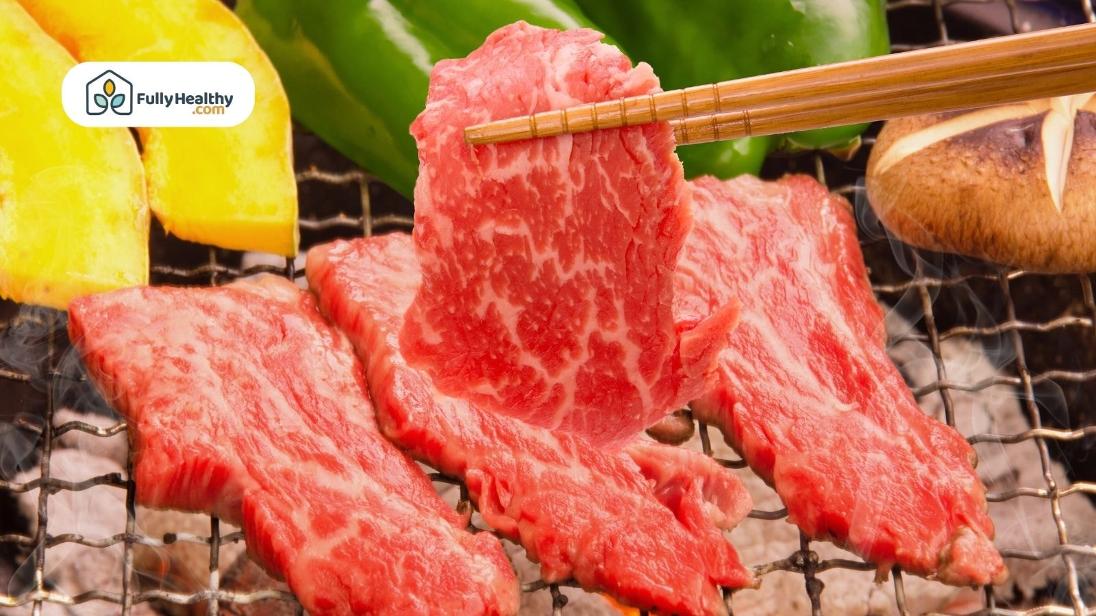 Wagyu slices being grilled with vegetables and chopsticks on barbecue
