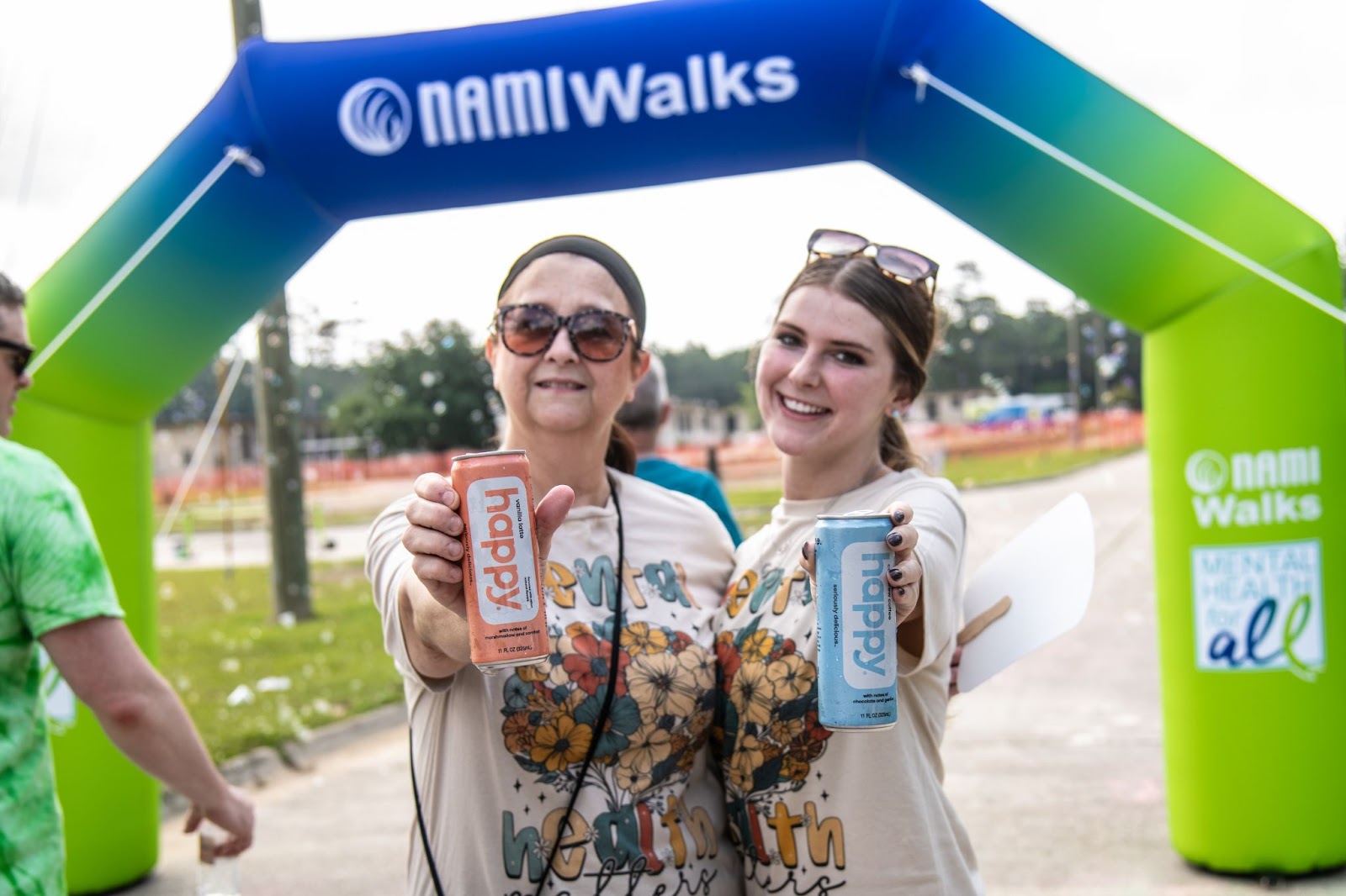 two NAMI walkers holding happy