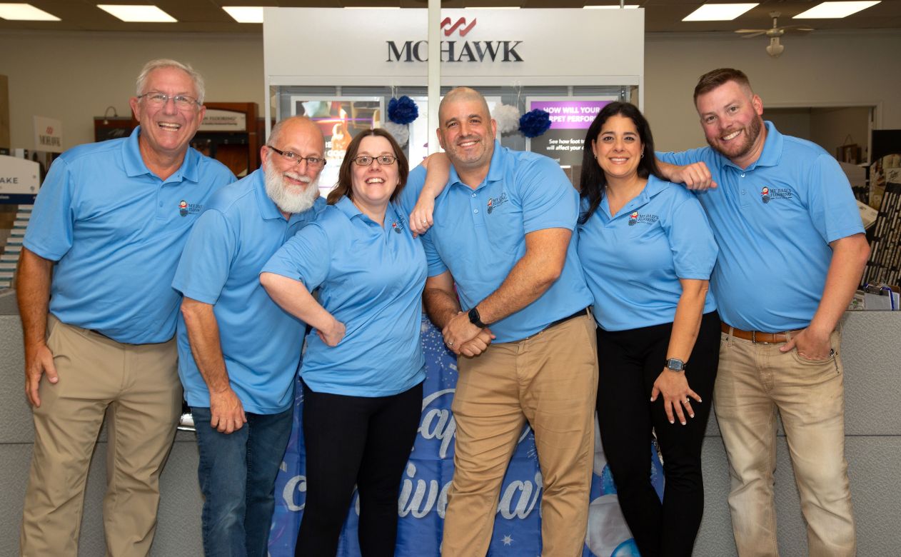 the My Dad's Flooring America team posing together at their office