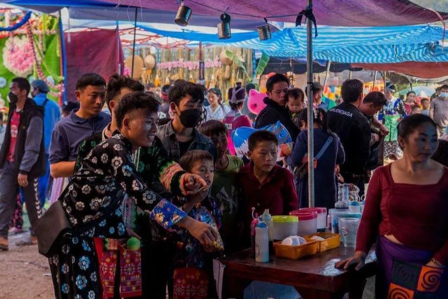 Hmong young men play games at the festival fair 