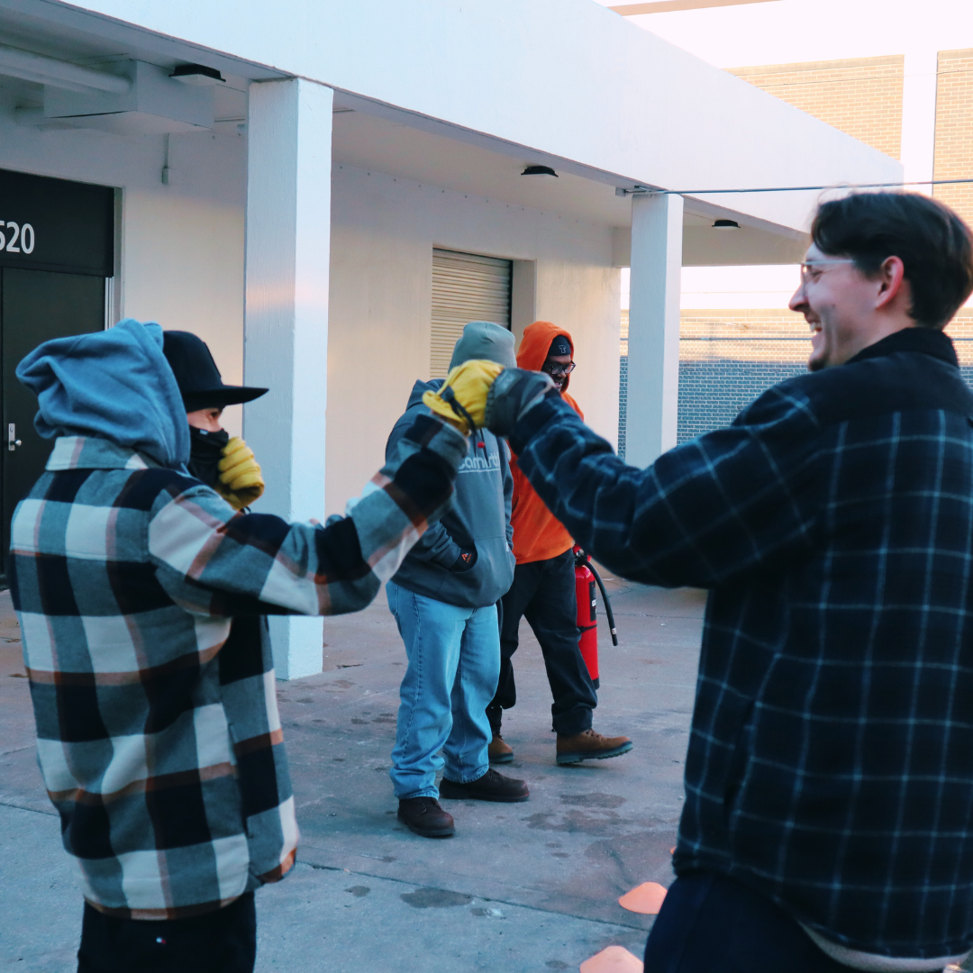 Pinnacle Career Institute Wind Turbine Technician Students fist bumping