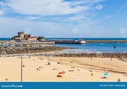 A beach with a body of water and a castle

Description automatically generated