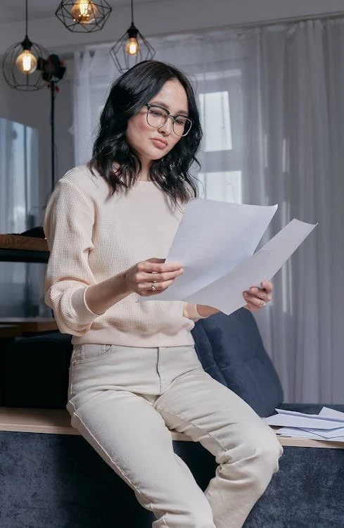 a woman in glass holding a paper