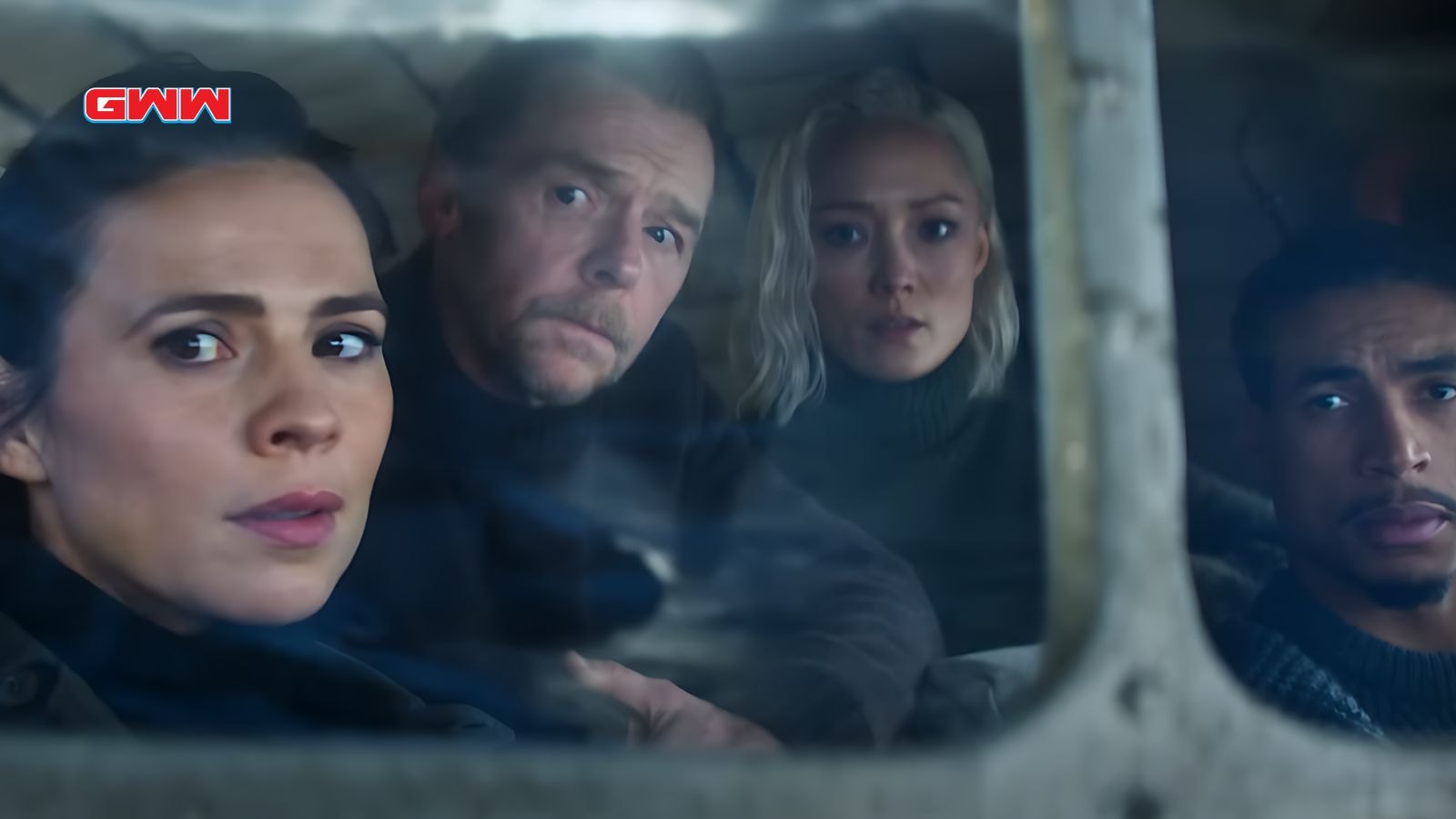  Team looks out a window, featuring Simon Pegg and Grace.