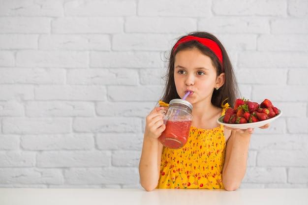 https://img.freepik.com/free-photo/girl-drinking-juice-holding-plate-strawberries_23-2147855327.jpg?semt=ais_hybrid