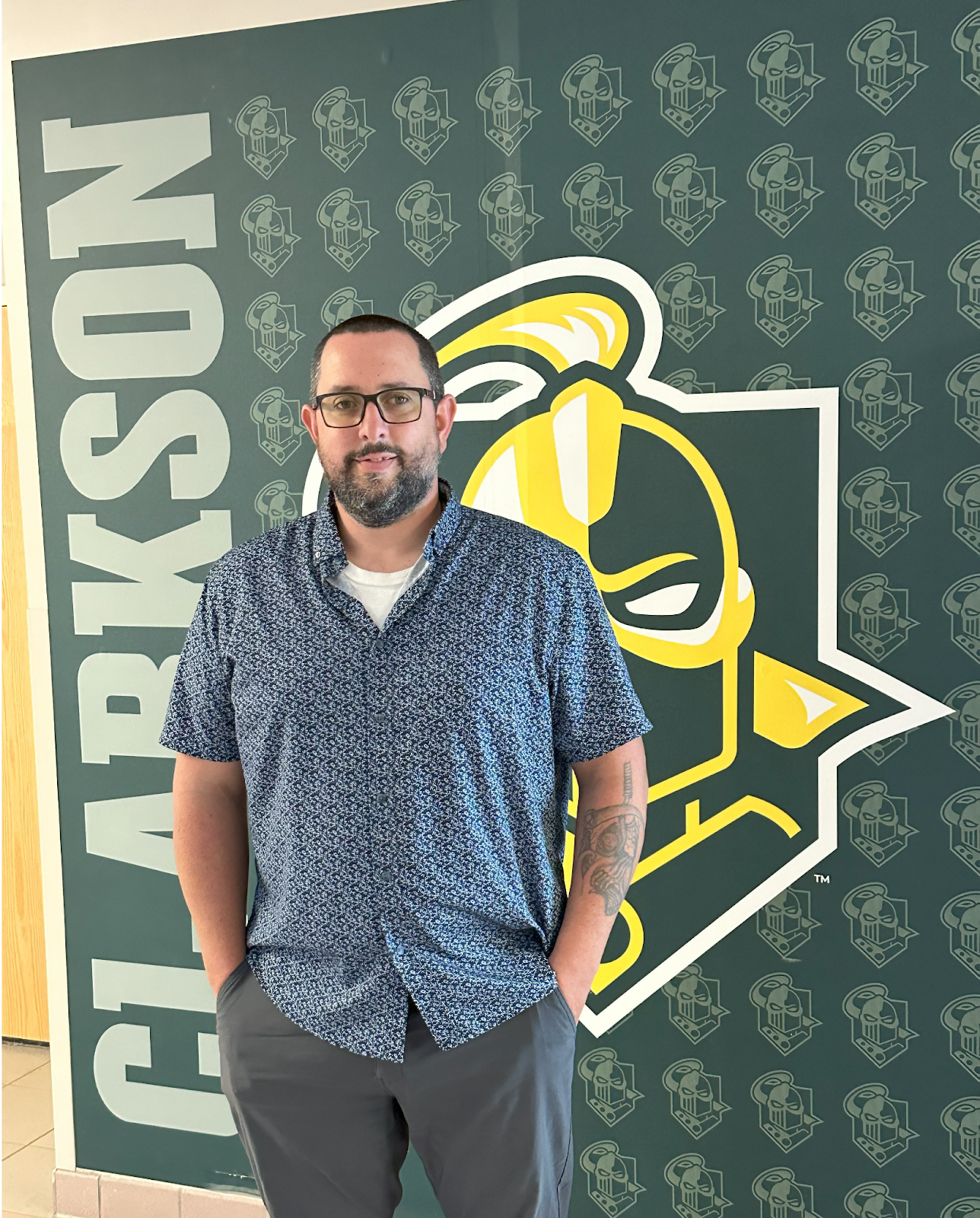 James Harris standing in front of Golden Knight mural.