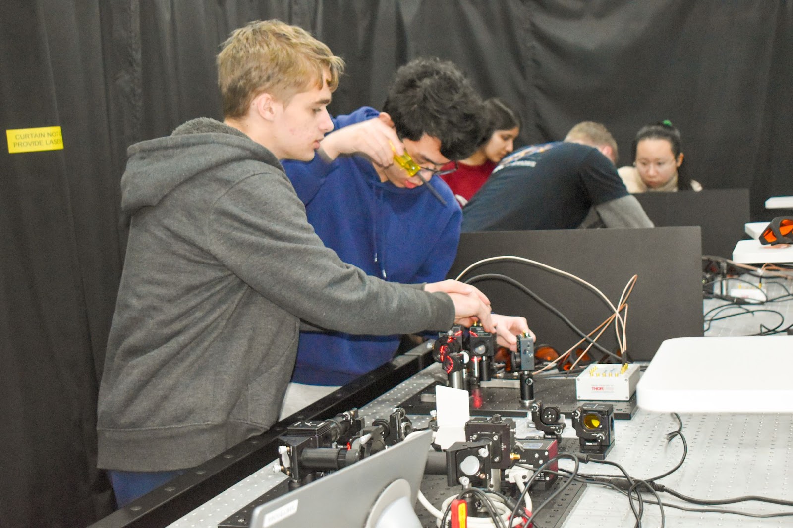 Students from Thomas Jefferson High School for Science and Technology doing science experiments in a mobile lab. 