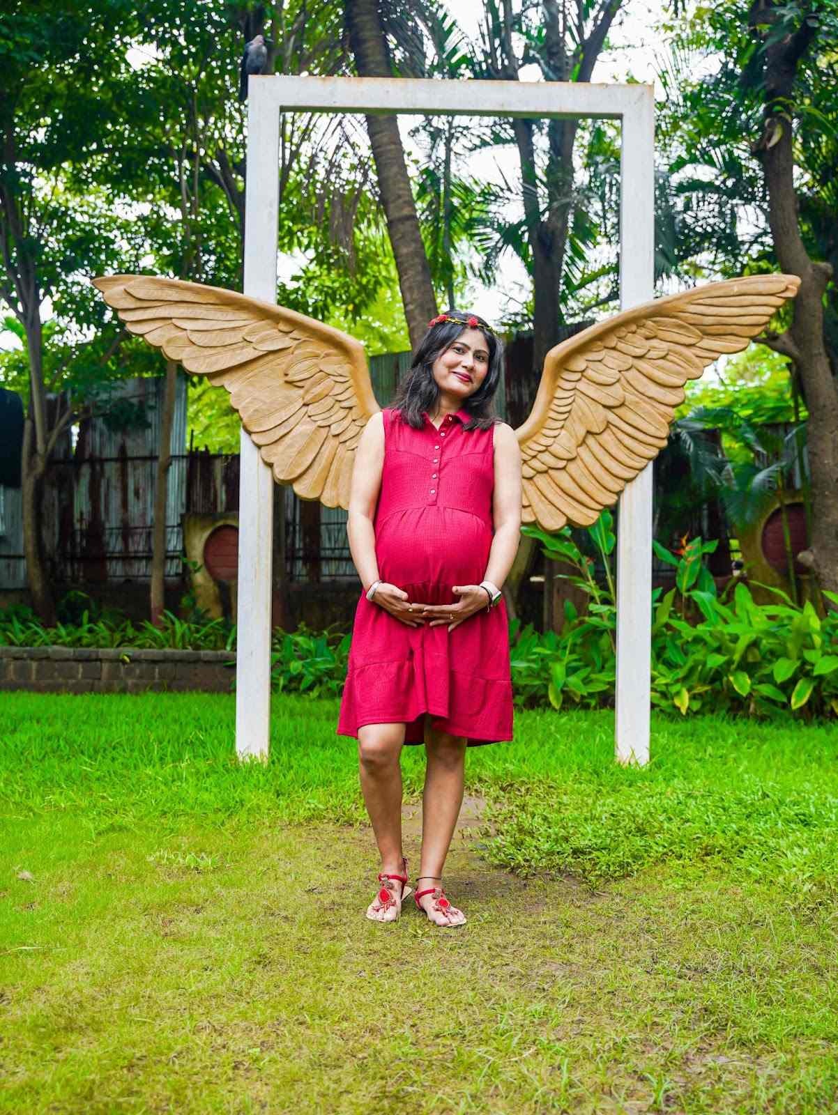 Serene maternity photoshoot with mother-to-be in a lush green park