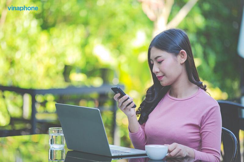 A person sitting at a table with a computer and a phone

Description automatically generated