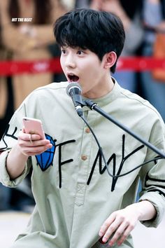 This contains an image of:  Dowoon holding a phone 