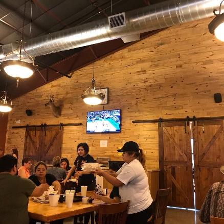 A group of people sitting at tables in a restaurant