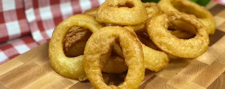 Onion rings placed on a wooden board