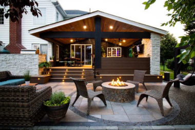 combining hardscaping and decking for a unique outdoor living space fire pit area with furniture custom built michigan