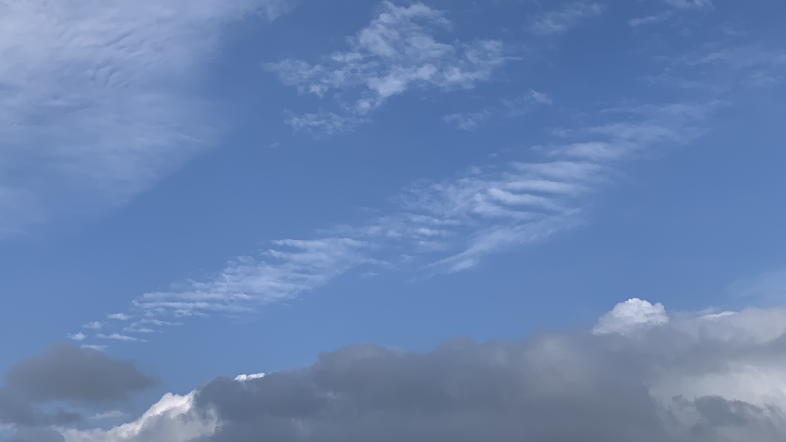 Some gray clouds along the bottom of the image and then blue sky with those clouds that kinda look like a rack of fish bones