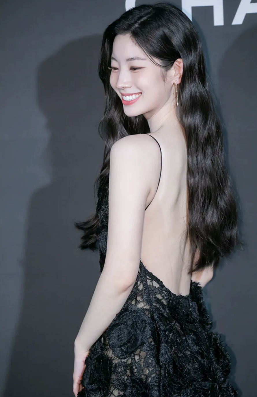 A picture of TWICE's Dahyun wearing a black backless dress 