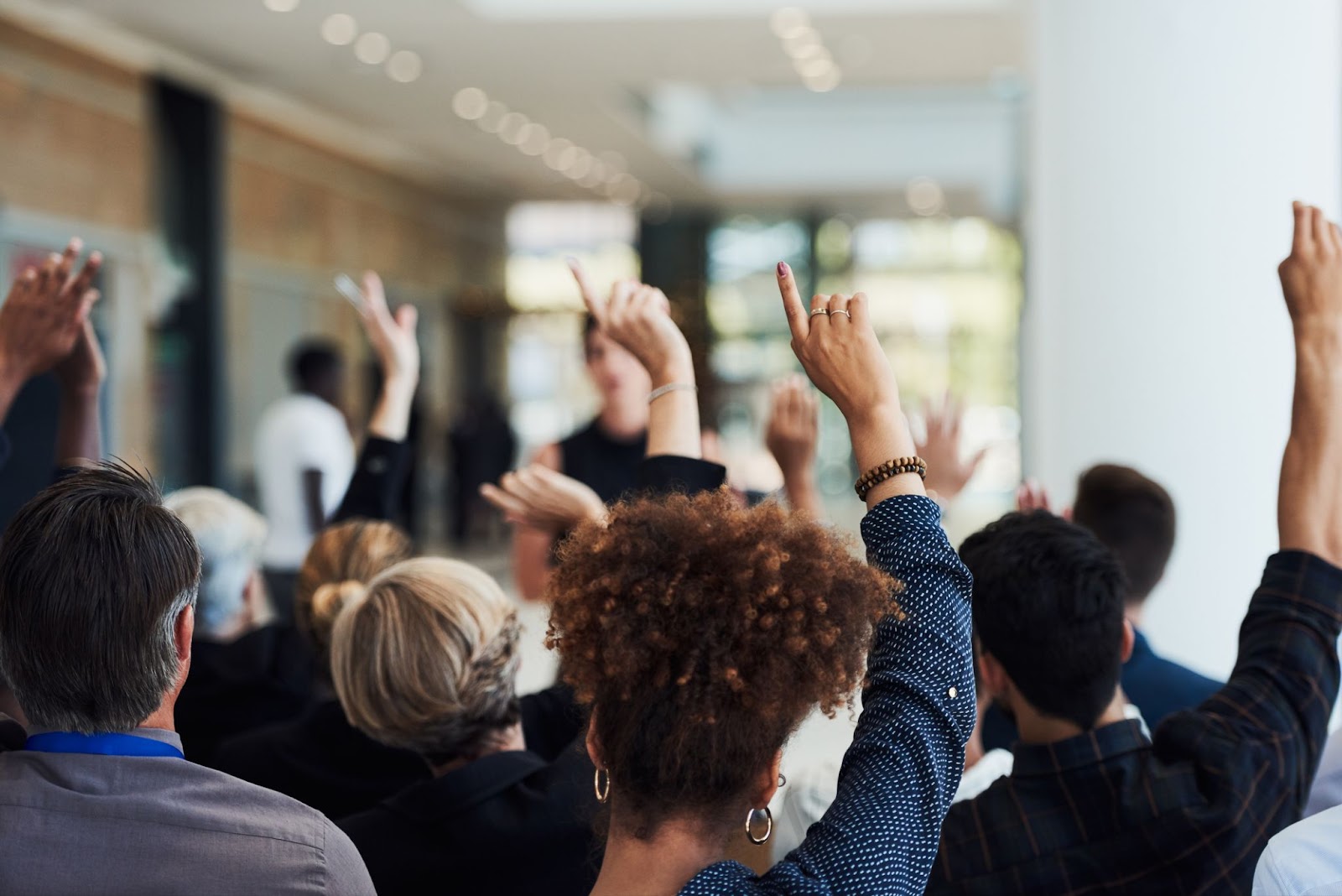 Bank employees raising their hands to volunteer