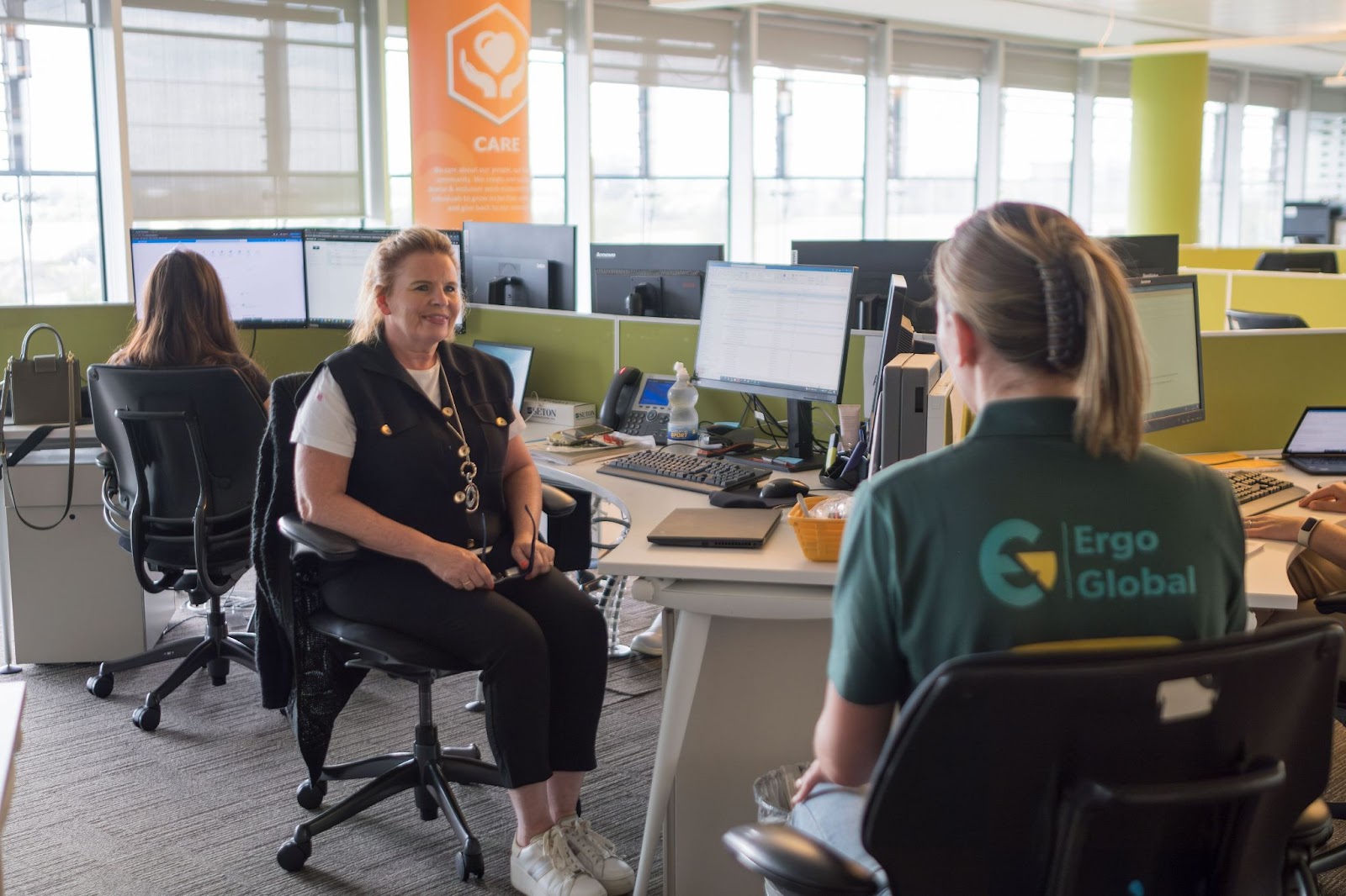 An ergonomics assessment specialist talking with a worker