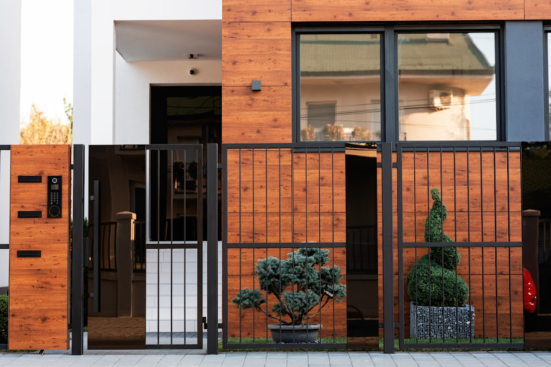 A front view of a modern home with fenced entrance. 
