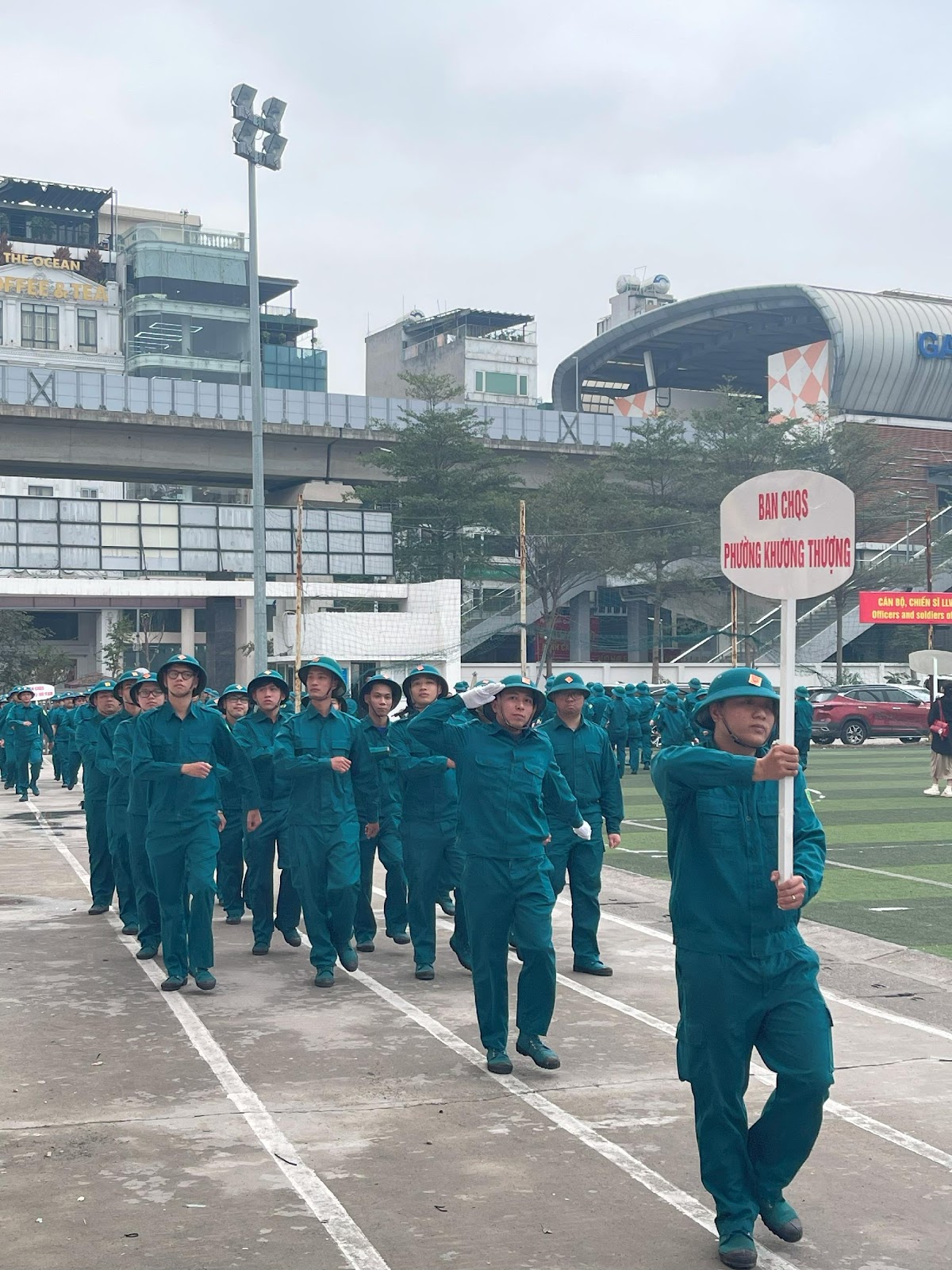 A group of people in blue uniforms walking on a road

AI-generated content may be incorrect.