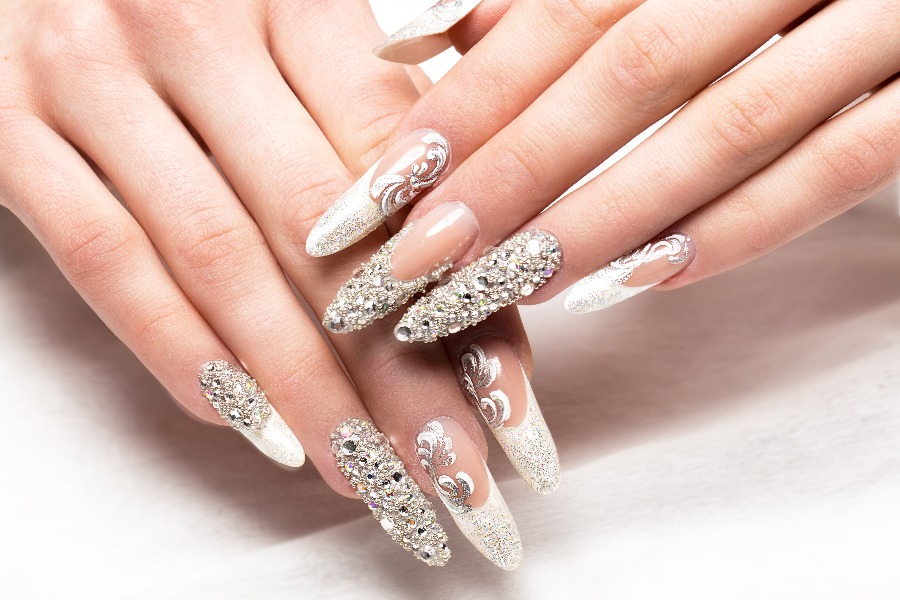 Crystal prism details reflect light beautifully in a glamorous French nail tip design.