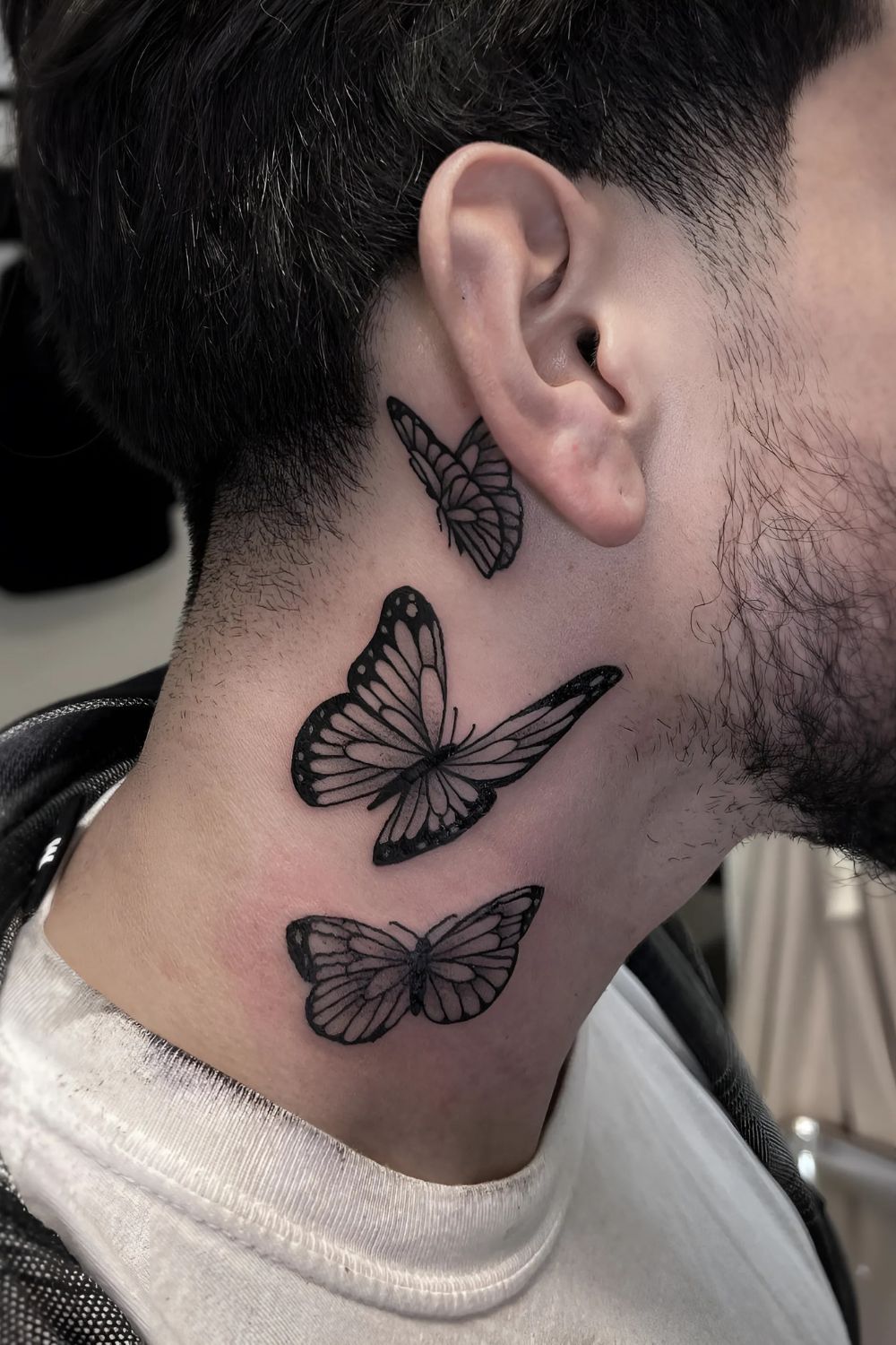Vibrant Butterfly Neck Tattoo
