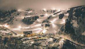 an image of cherry peaks lit up at night showing the runs they have at night