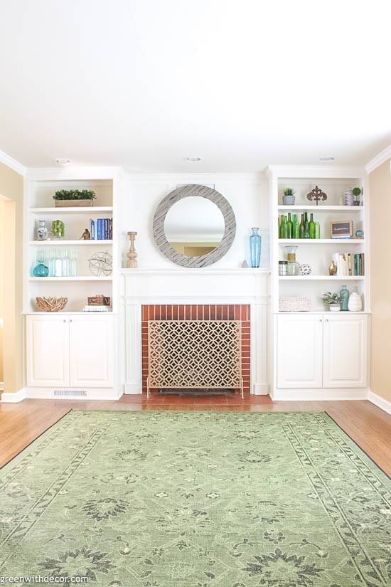 a room with white cabinets and a rug